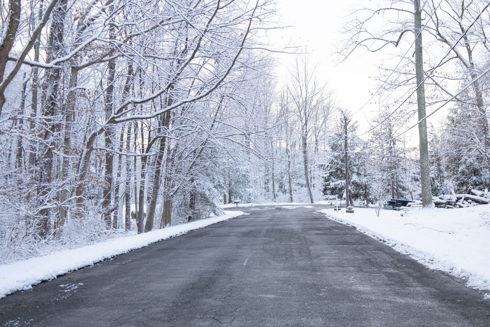 Snow-covered property with plowed driveway
